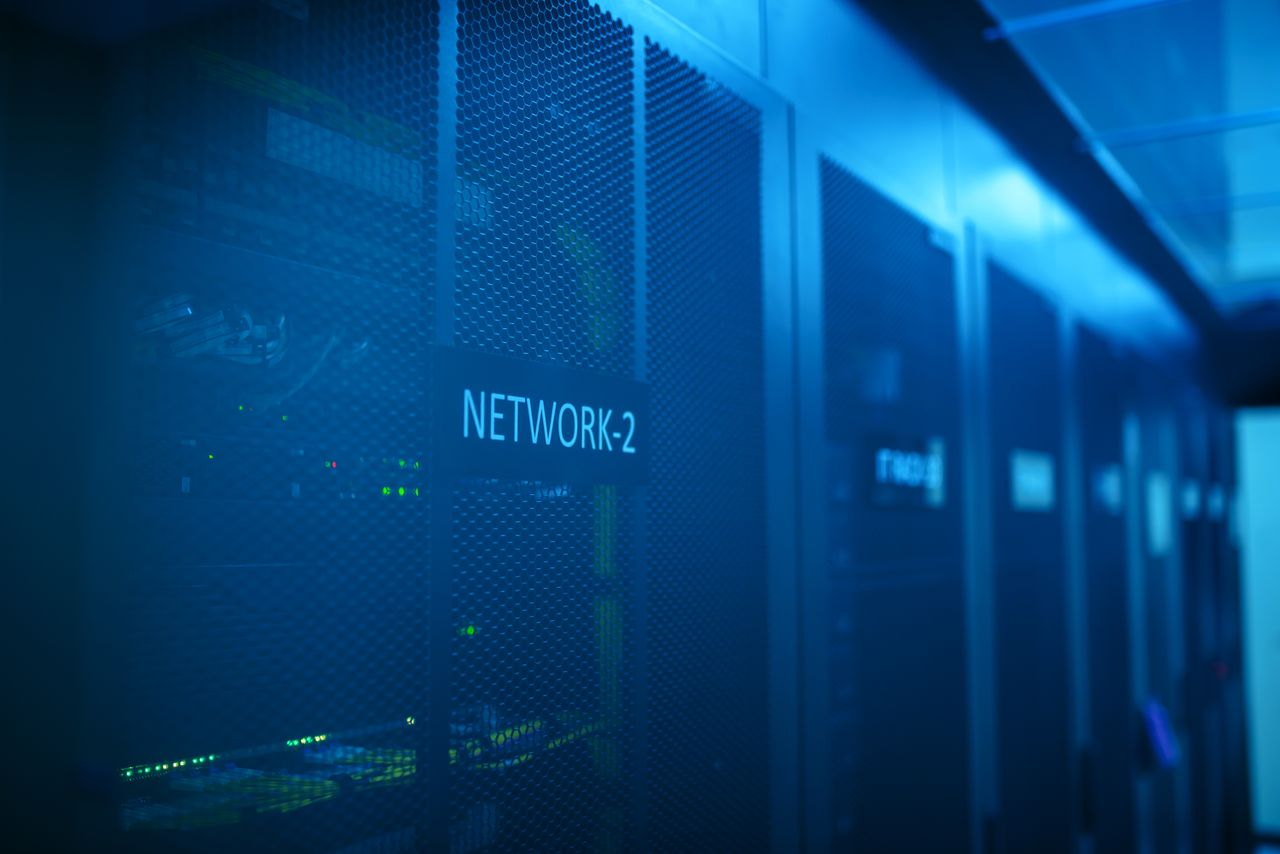 Services A modern server room featuring network equipment with blue illumination. Ideal for technology themes.
